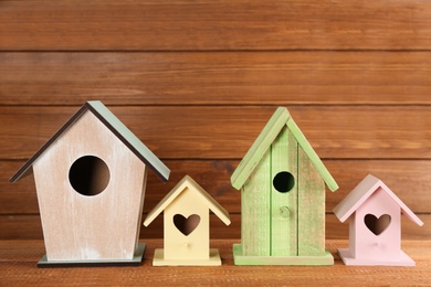 Photo of Collection of handmade bird houses on wooden table
