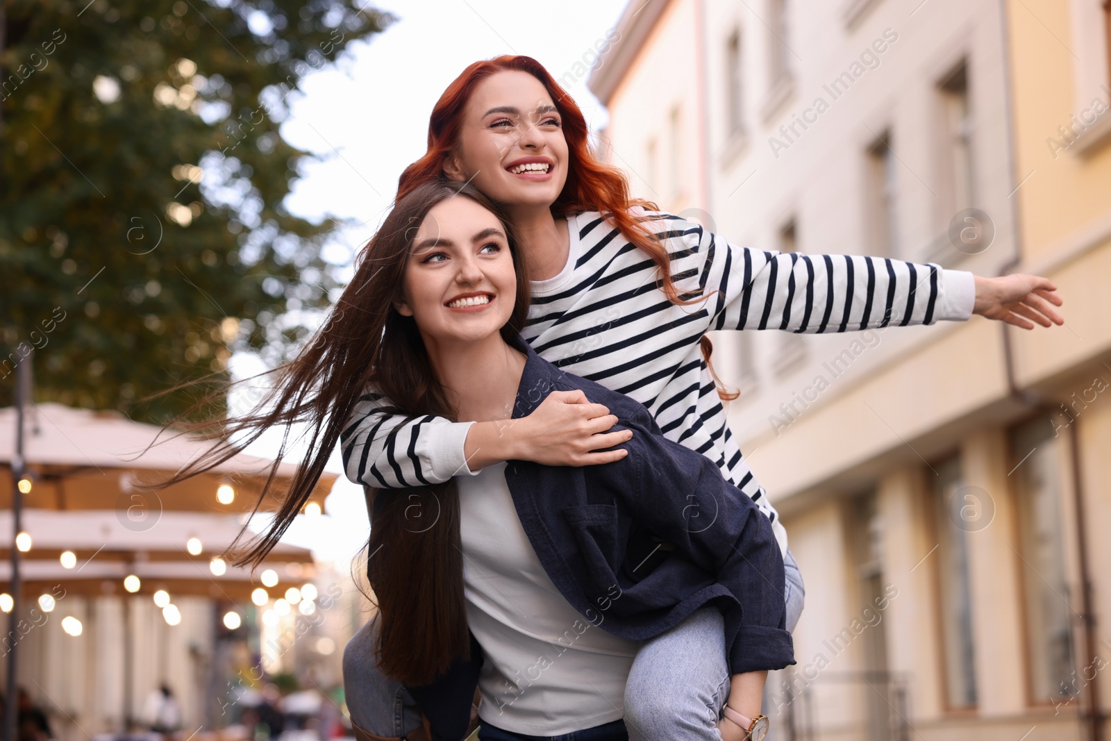 Photo of Happy friends having fun on city street