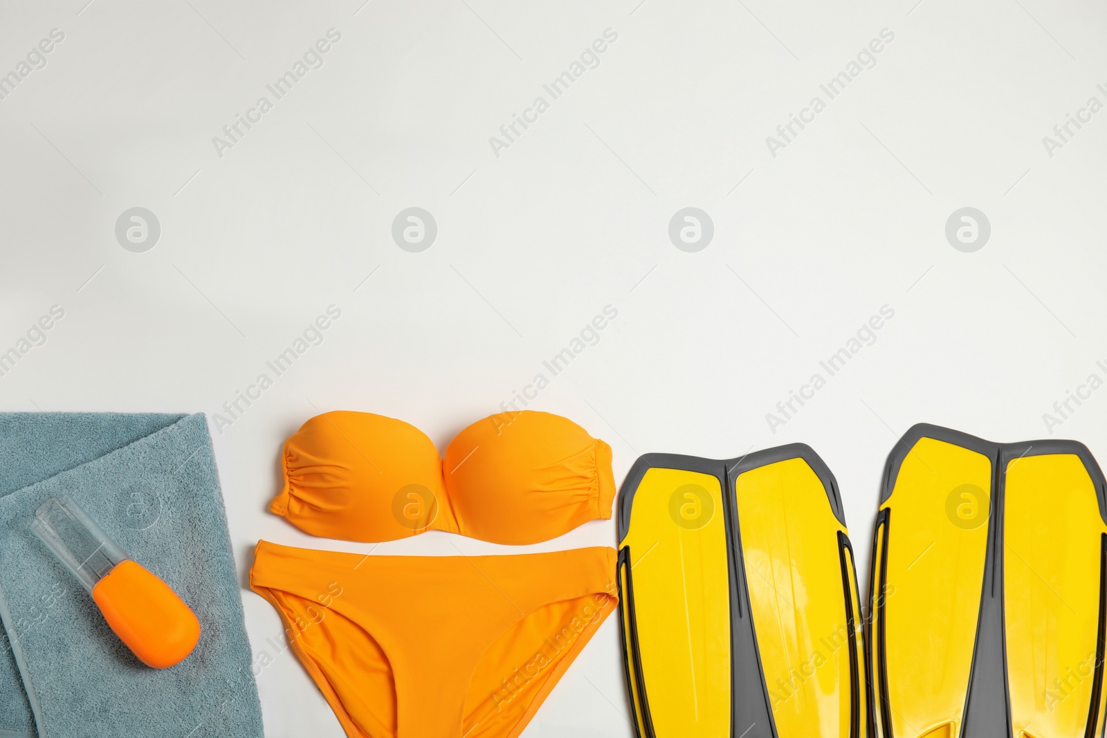 Photo of Flat lay composition with beach objects on light background. Space for text