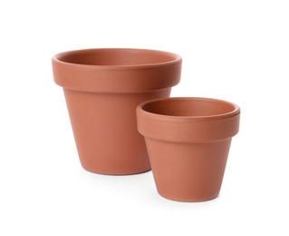 Photo of Stylish terracotta flower pots isolated on white