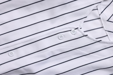 Striped baseball shirt as background, top view