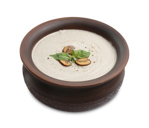 Fresh homemade mushroom soup in ceramic pot isolated on white