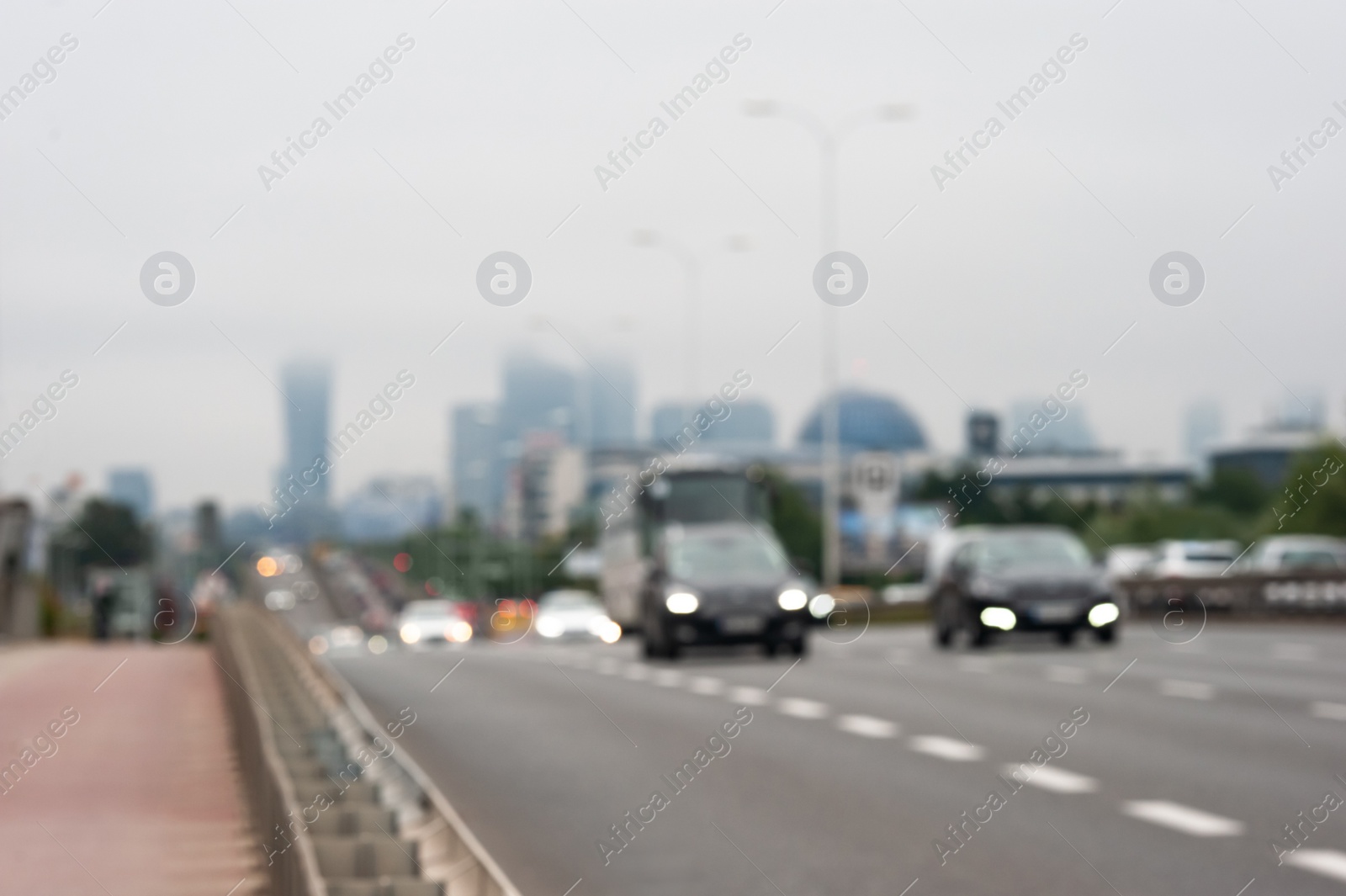 Photo of Blurred view of city road with cars