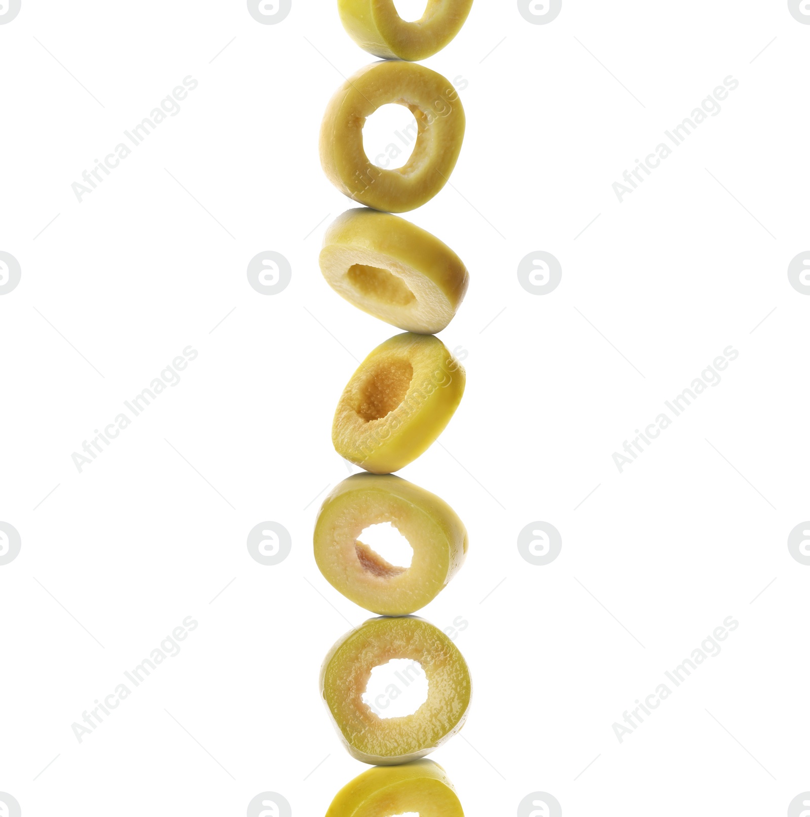 Image of Stacked slices of green olive on white background