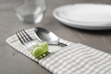 Beautiful table setting on grey background, closeup