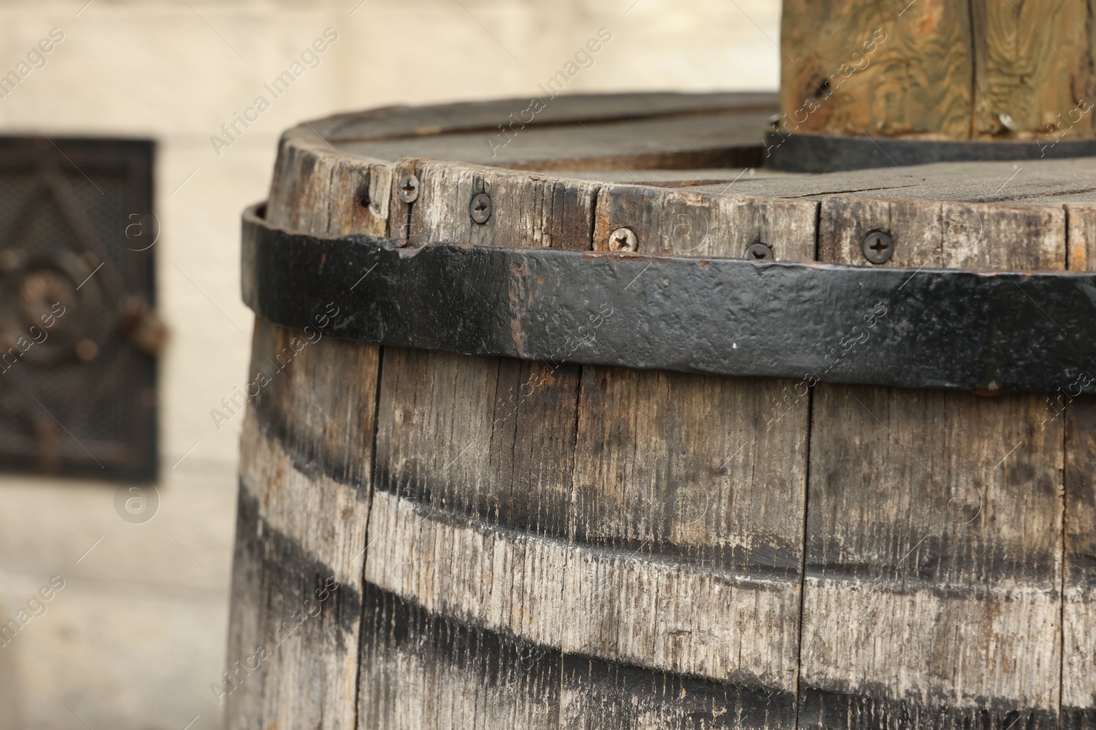 Photo of Traditional wooden barrel outdoors, closeup. Wine making