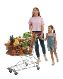 Photo of Mother and daughter with full shopping cart on white background