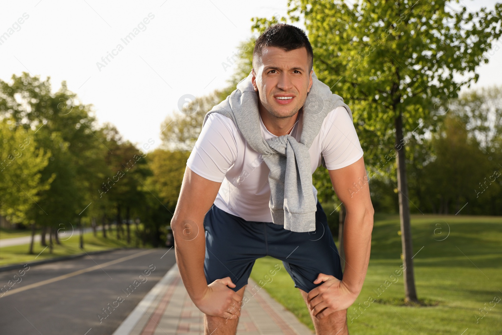Photo of Young man resting after fitness exercise outdoors