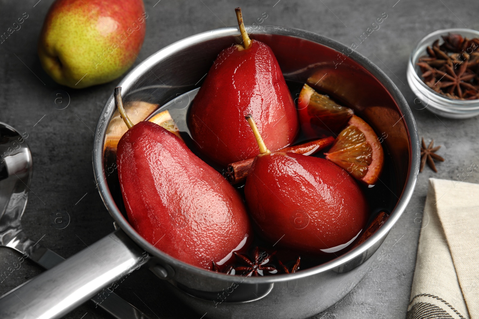 Image of Poaching pears in mulled wine on table, closeup