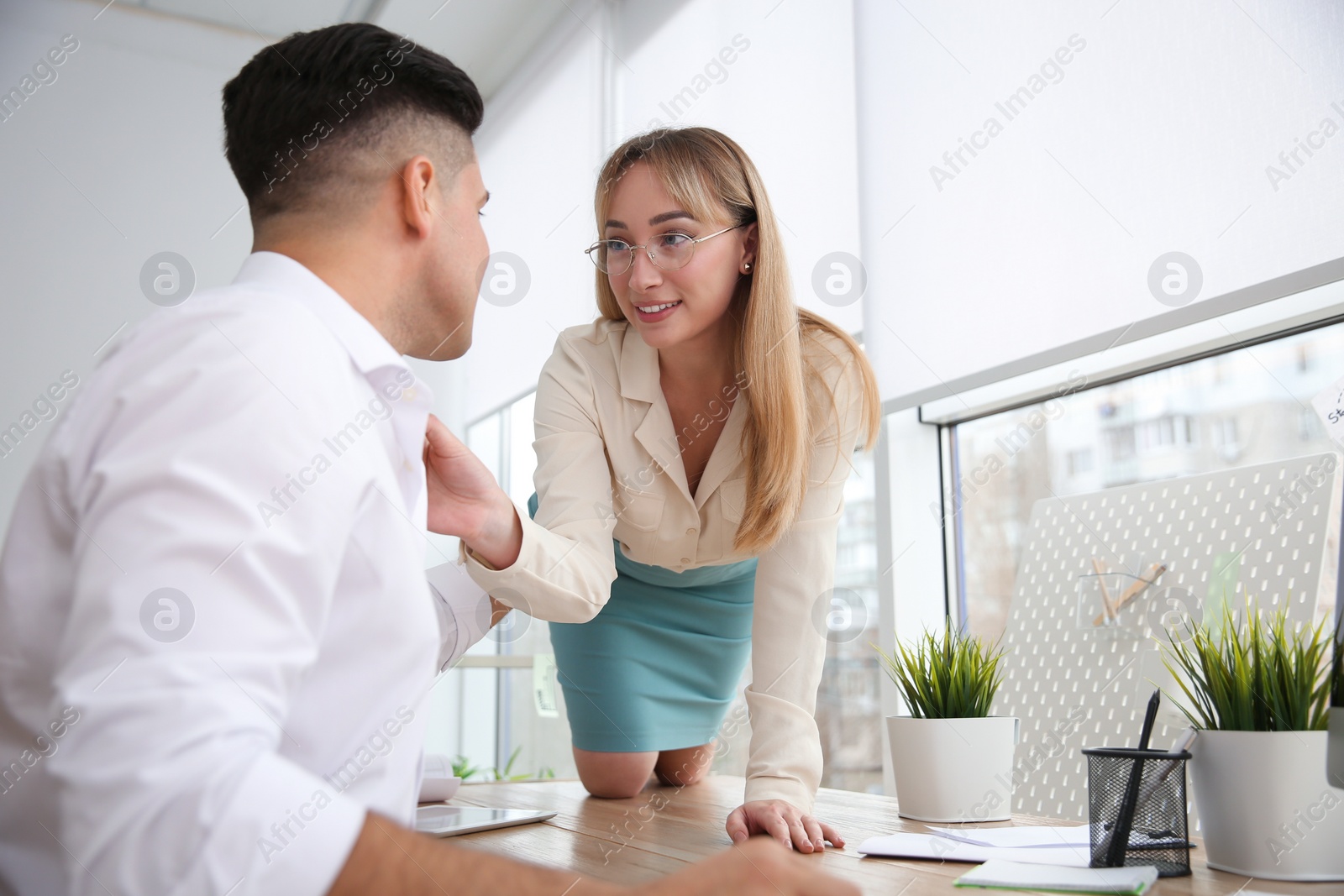 Photo of Colleagues flirting with each other during work in office