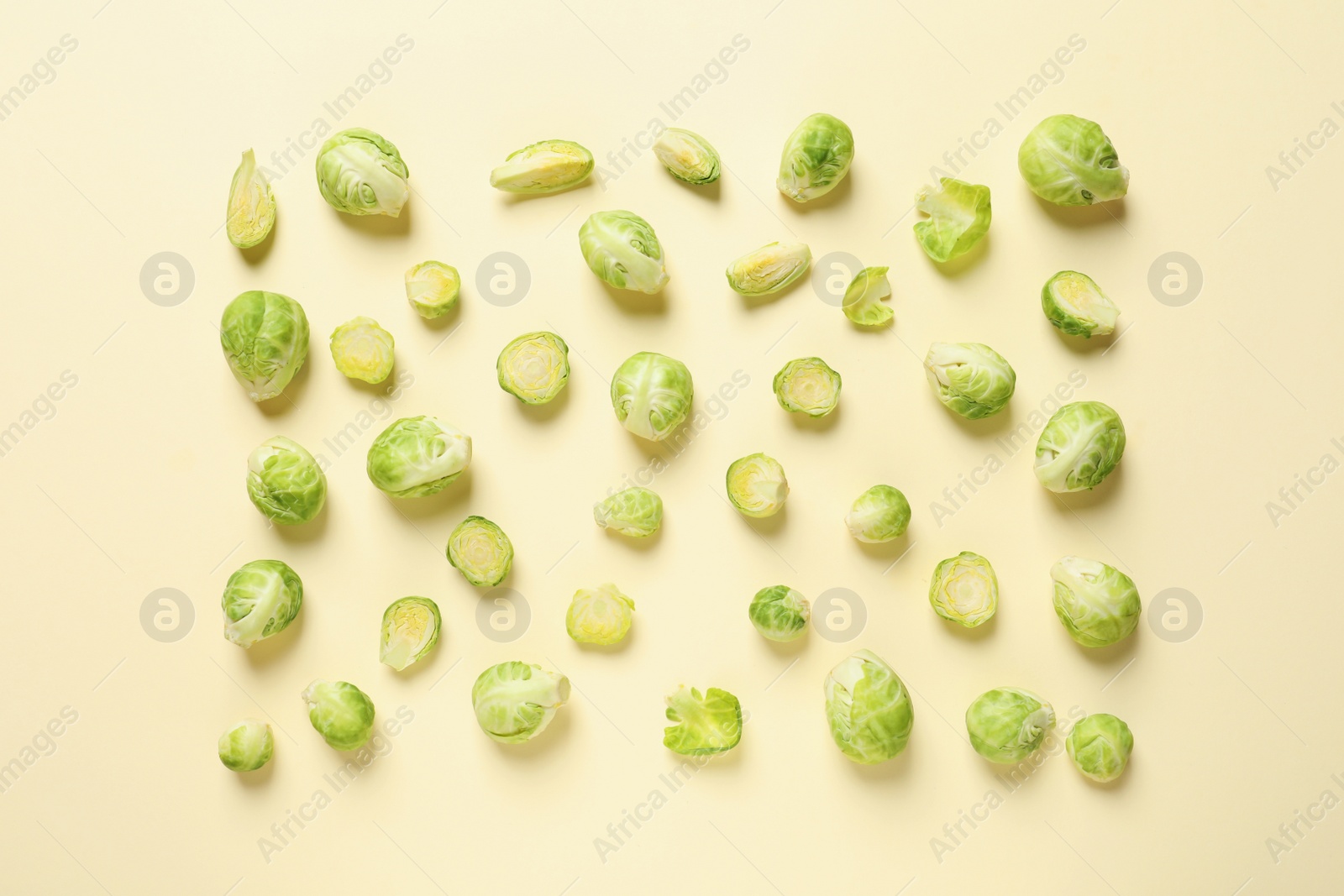 Photo of Fresh Brussels sprouts on color background, flat lay