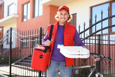 Male courier delivering food in city on sunny day