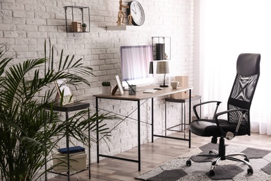 Photo of Comfortable chair near desk in modern office interior