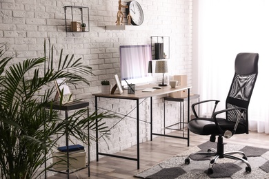 Comfortable chair near desk in modern office interior