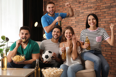 Photo of Group of friends watching football at home