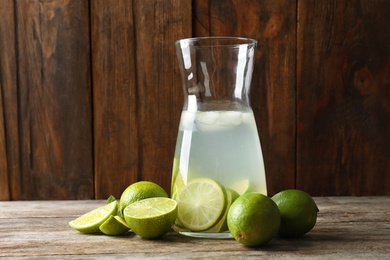 Natural lemonade with lime in bottle on wooden table