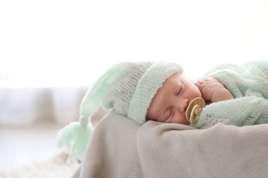 Photo of Cute newborn baby sleeping on plaid in basket. Space for text
