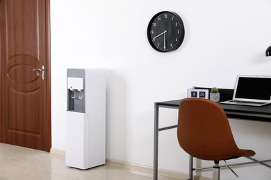 Photo of Modern water cooler in stylish office interior