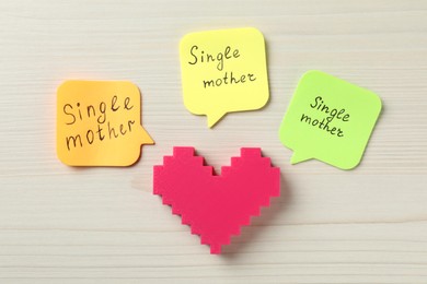 Photo of Heart and text Single mother on white wooden background, flat lay