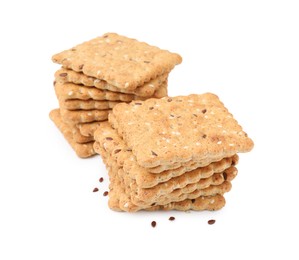 Photo of Stacks of cereal crackers with flax and sesame seeds isolated on white