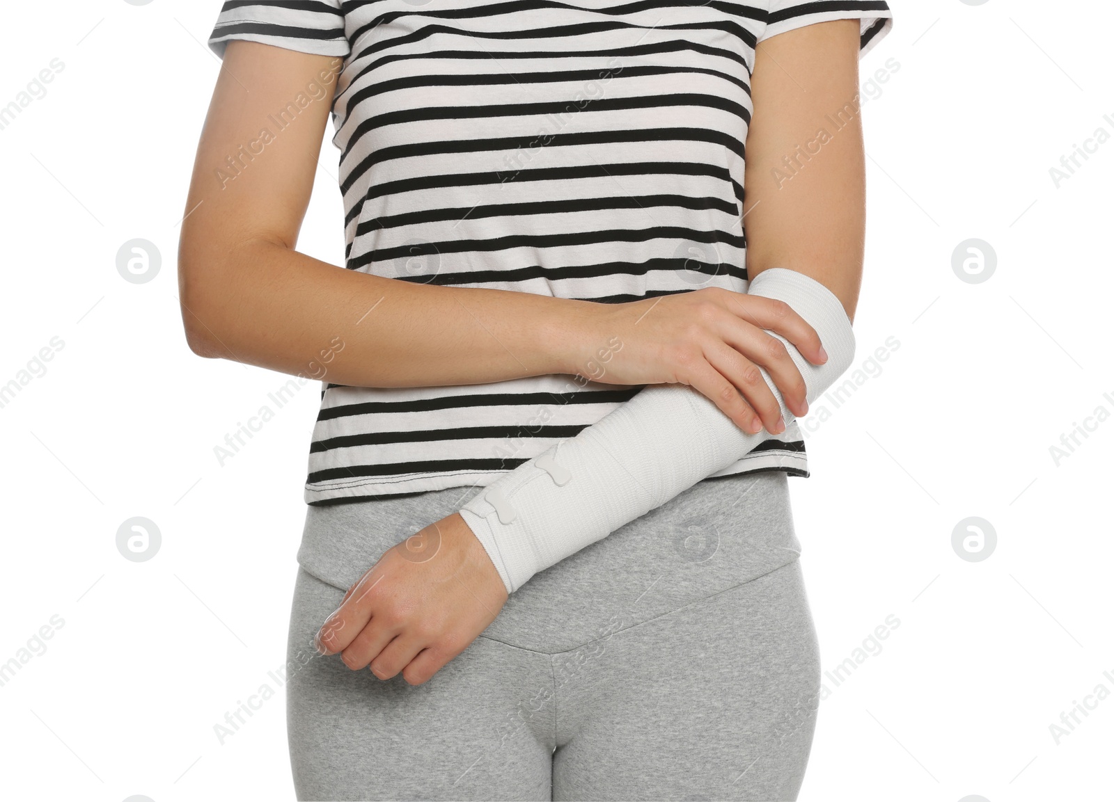 Photo of Young woman with arm wrapped in medical bandage on white background, closeup