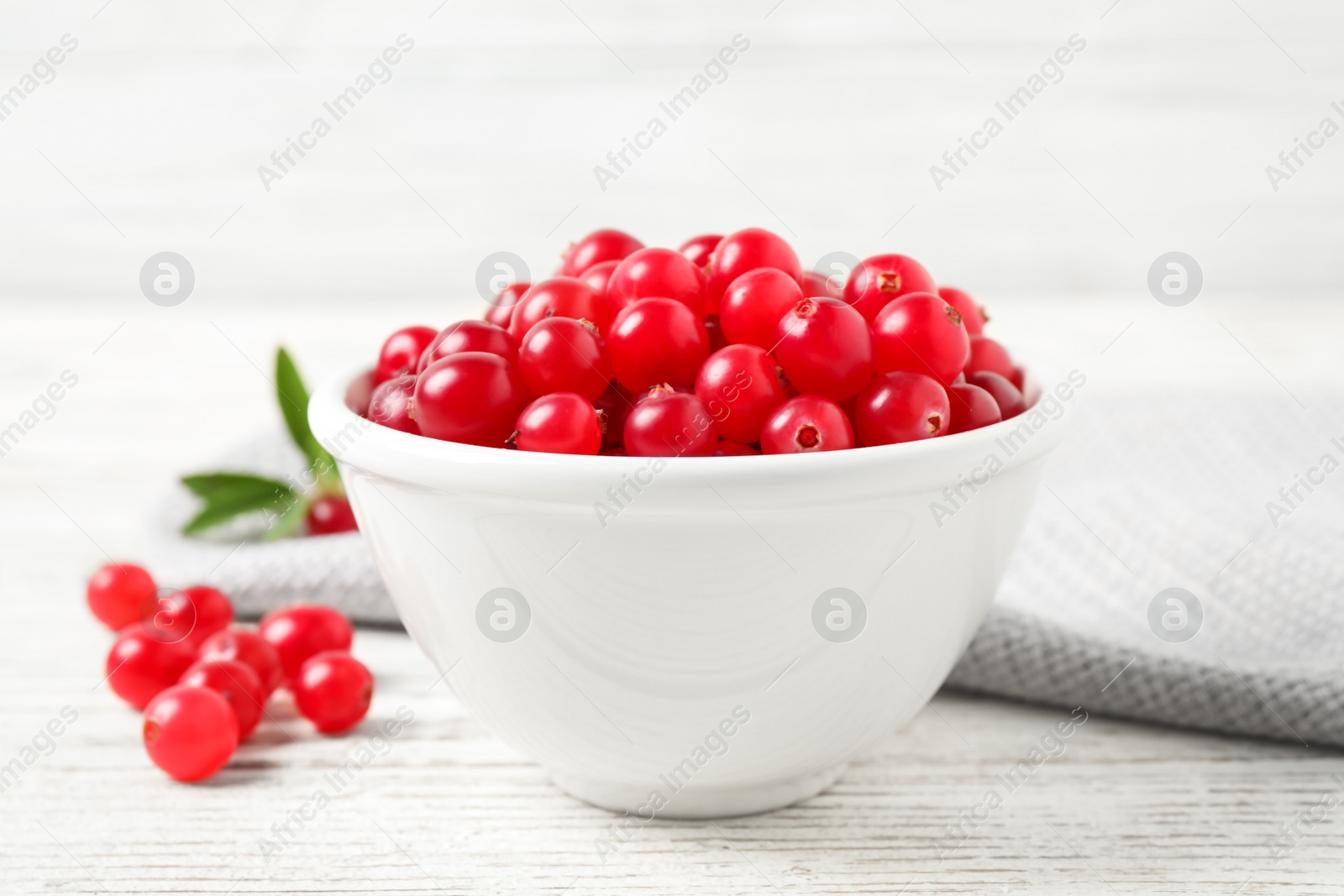 Photo of Tasty ripe cranberries on white wooden table, closeup