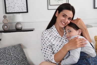 Portrait of happy mother and daughter hugging at home. Single parenting