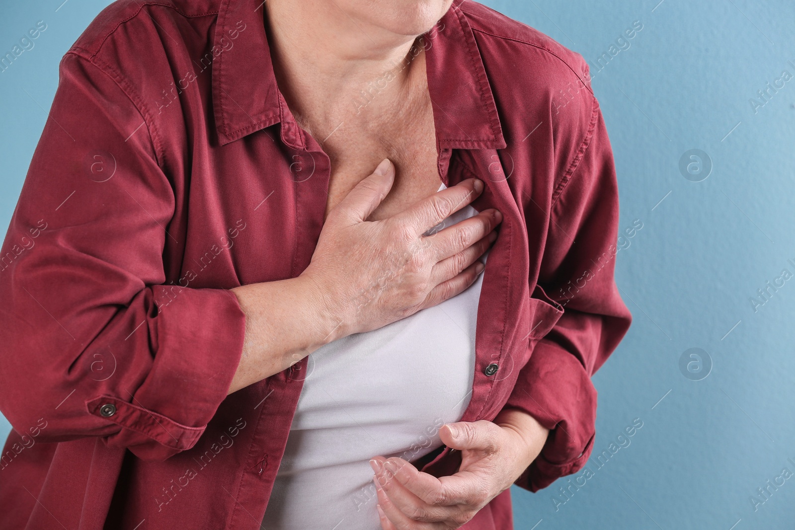 Photo of Mature woman having heart attack on color background