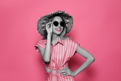 Attractive woman in stylish sunglasses on pink background. Color accent