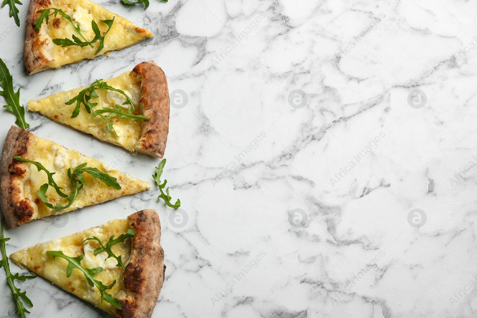 Photo of Tasty cheese pizza with arugula on white marble table, flat lay. Space for text