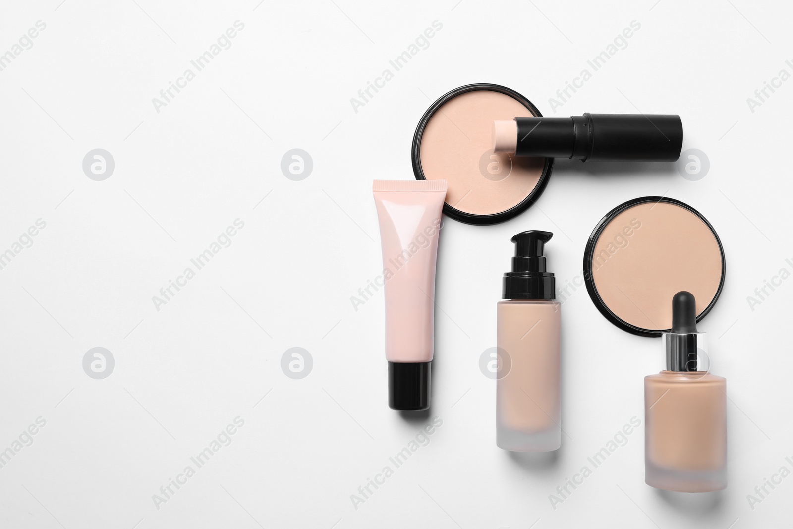 Photo of Different types of skin foundation on white background, flat lay with space for text. Makeup product