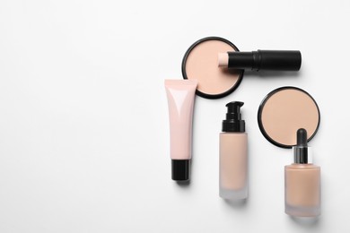 Different types of skin foundation on white background, flat lay with space for text. Makeup product