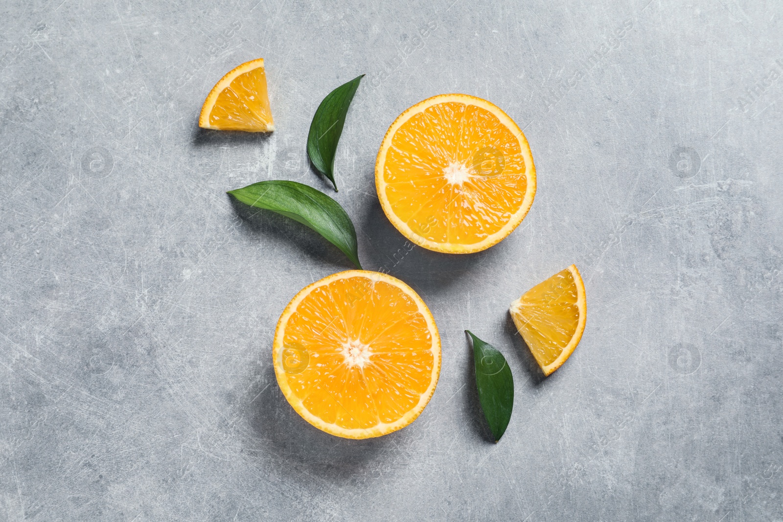 Photo of Flat lay composition with fresh oranges on grey background