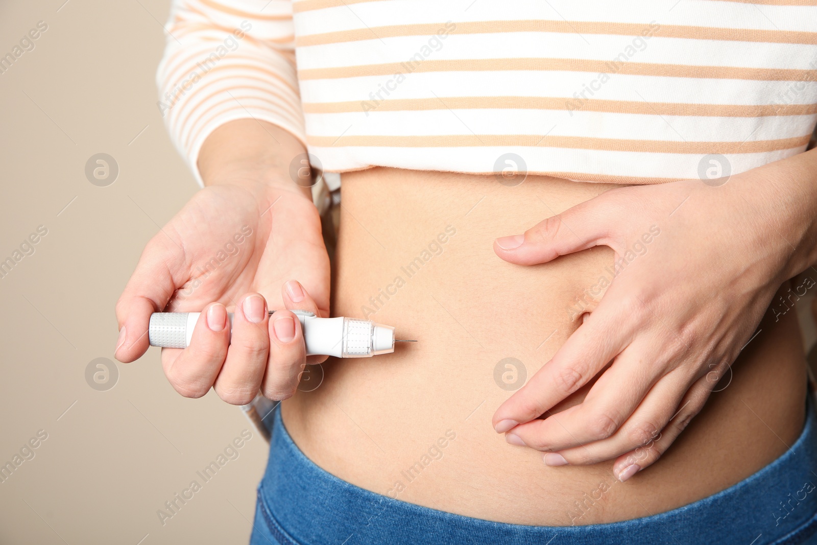 Photo of Woman doing insulin injection in stomach, closeup. Diabetes disease
