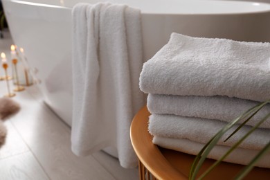 Fresh clean terry towels on table in bathroom. Space for text