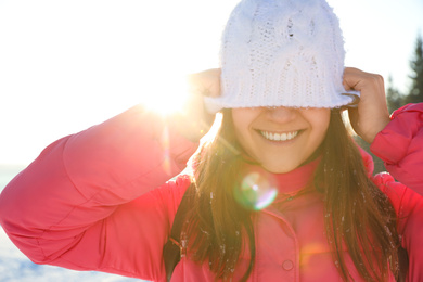 Young woman having fun outdoors on snowy winter day