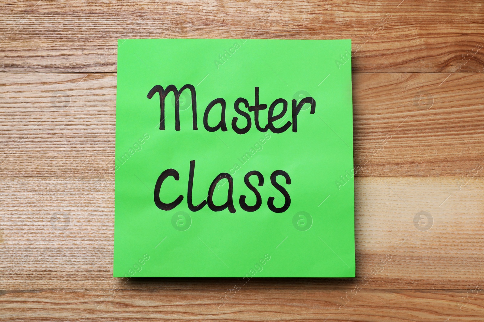 Photo of Green paper note with words Master Class on wooden table, top view