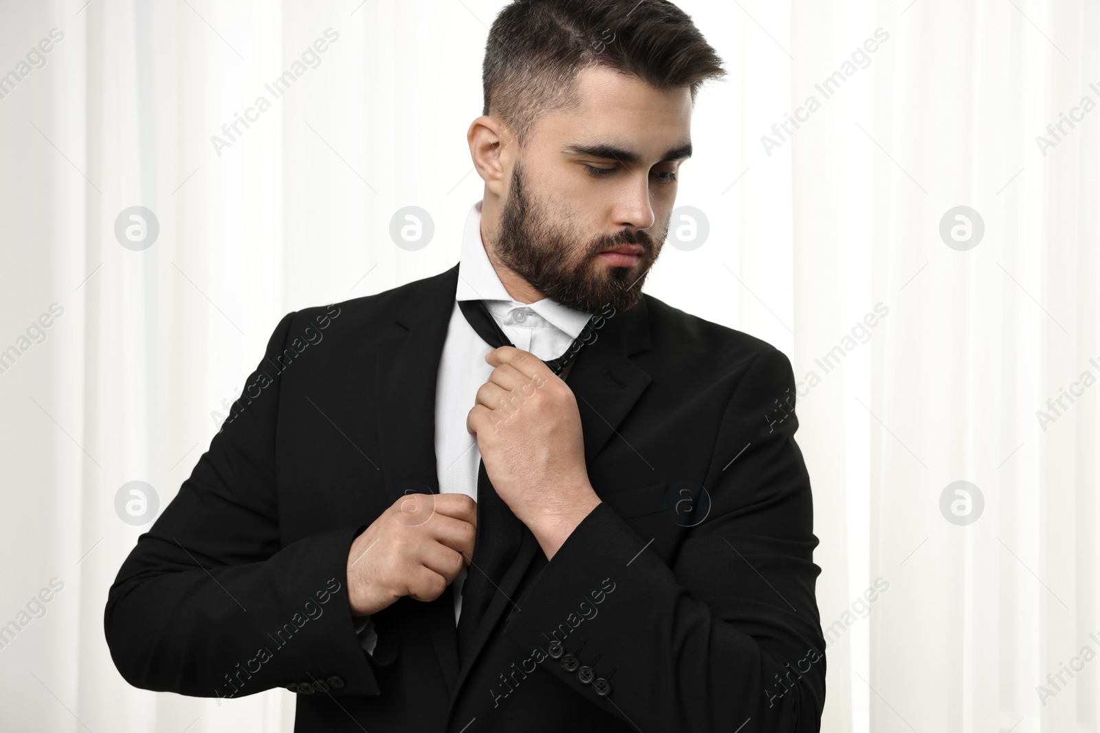 Photo of Handsome businessman in suit and necktie indoors