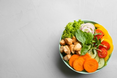 Photo of Delicious fresh chicken salad served on grey table, top view. Space for text