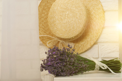 Beautiful lavender bouquet and straw hat indoors