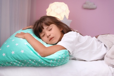 Photo of Little girl sleeping in bed at home