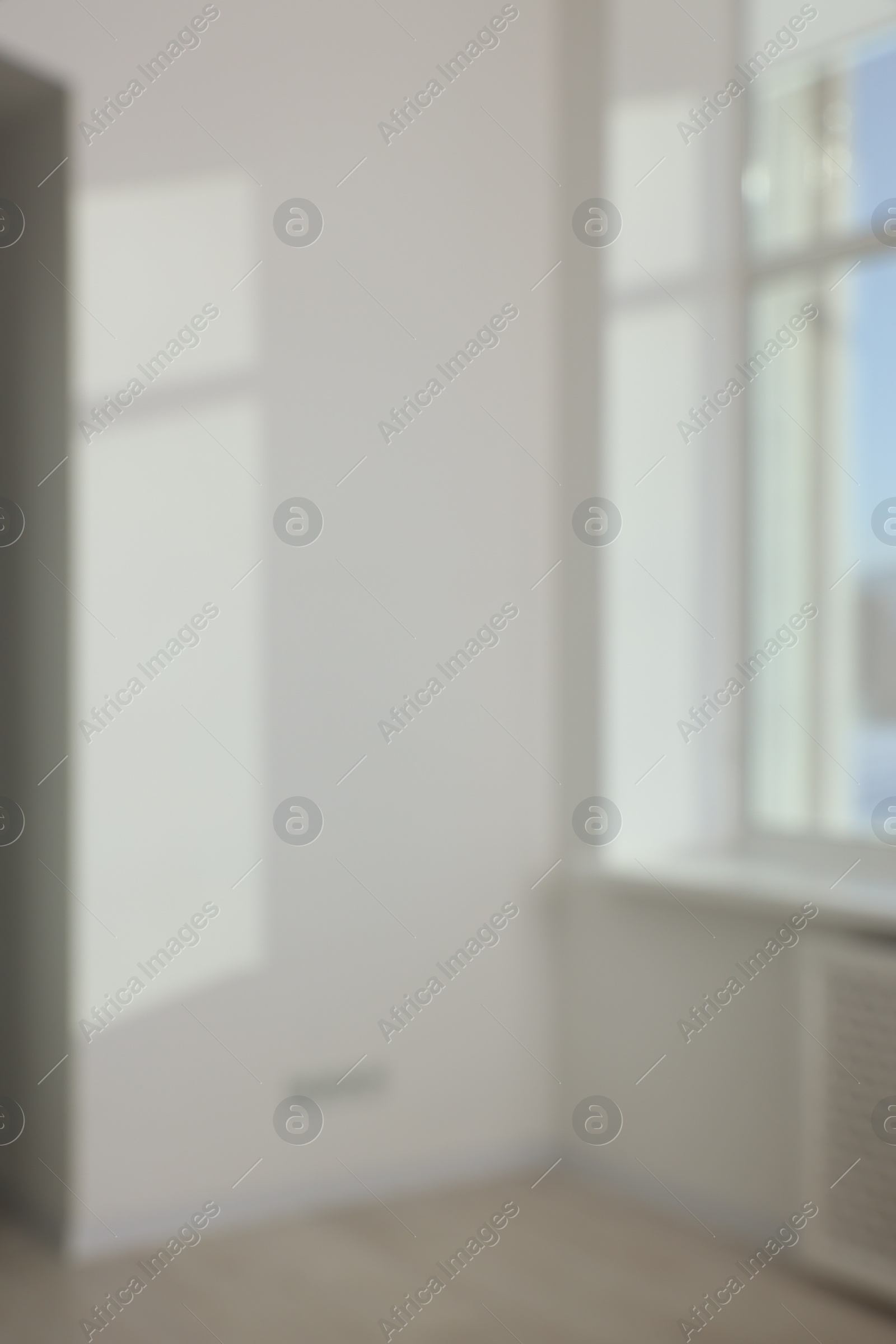 Photo of Blurred view of light and shadows from window on wall indoors