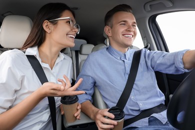 Happy young couple travelling together by car