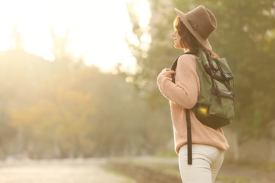 Photo of Traveler in hat with backpack on city street