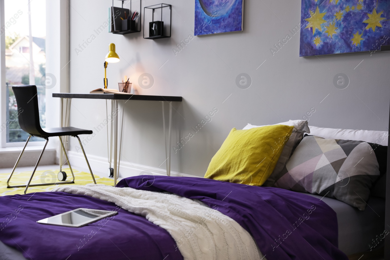 Photo of Modern teenager's room interior with comfortable bed, workplace and stylish design elements