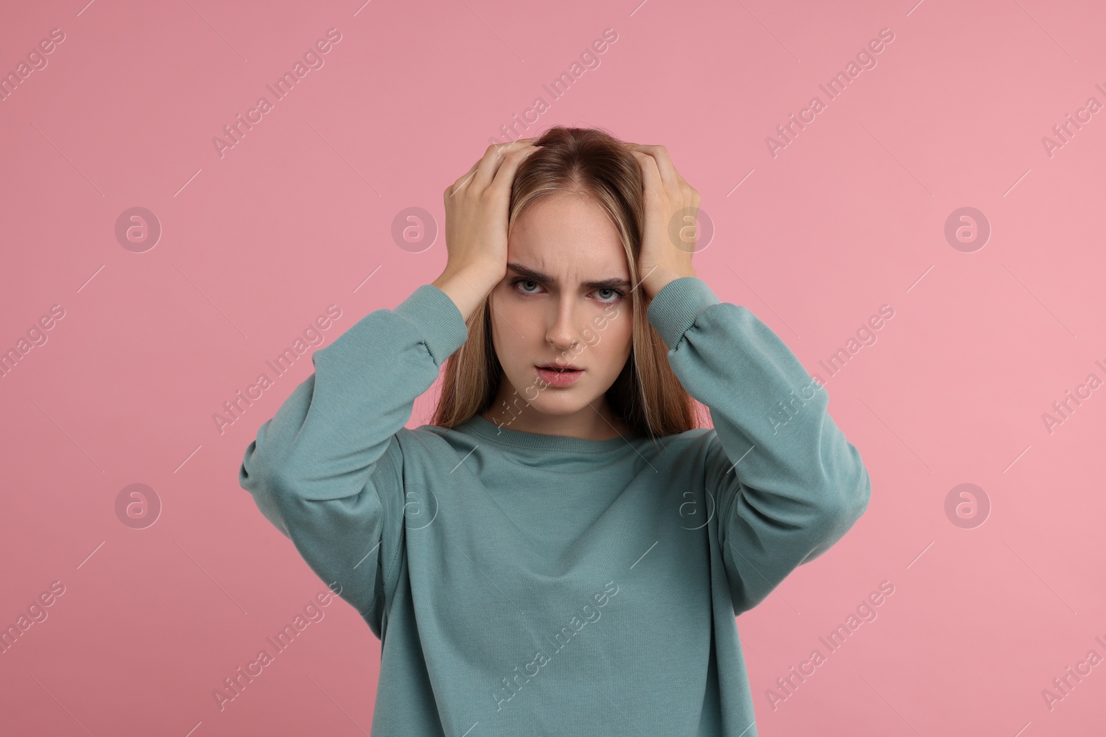 Photo of Portrait of resentful woman on pink background