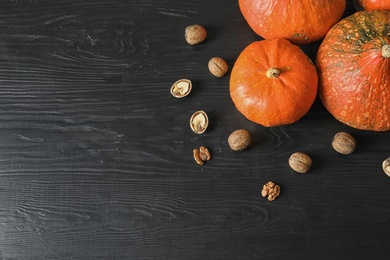 Photo of Orange pumpkins on dark background, flat lay composition with space for text. Autumn holidays