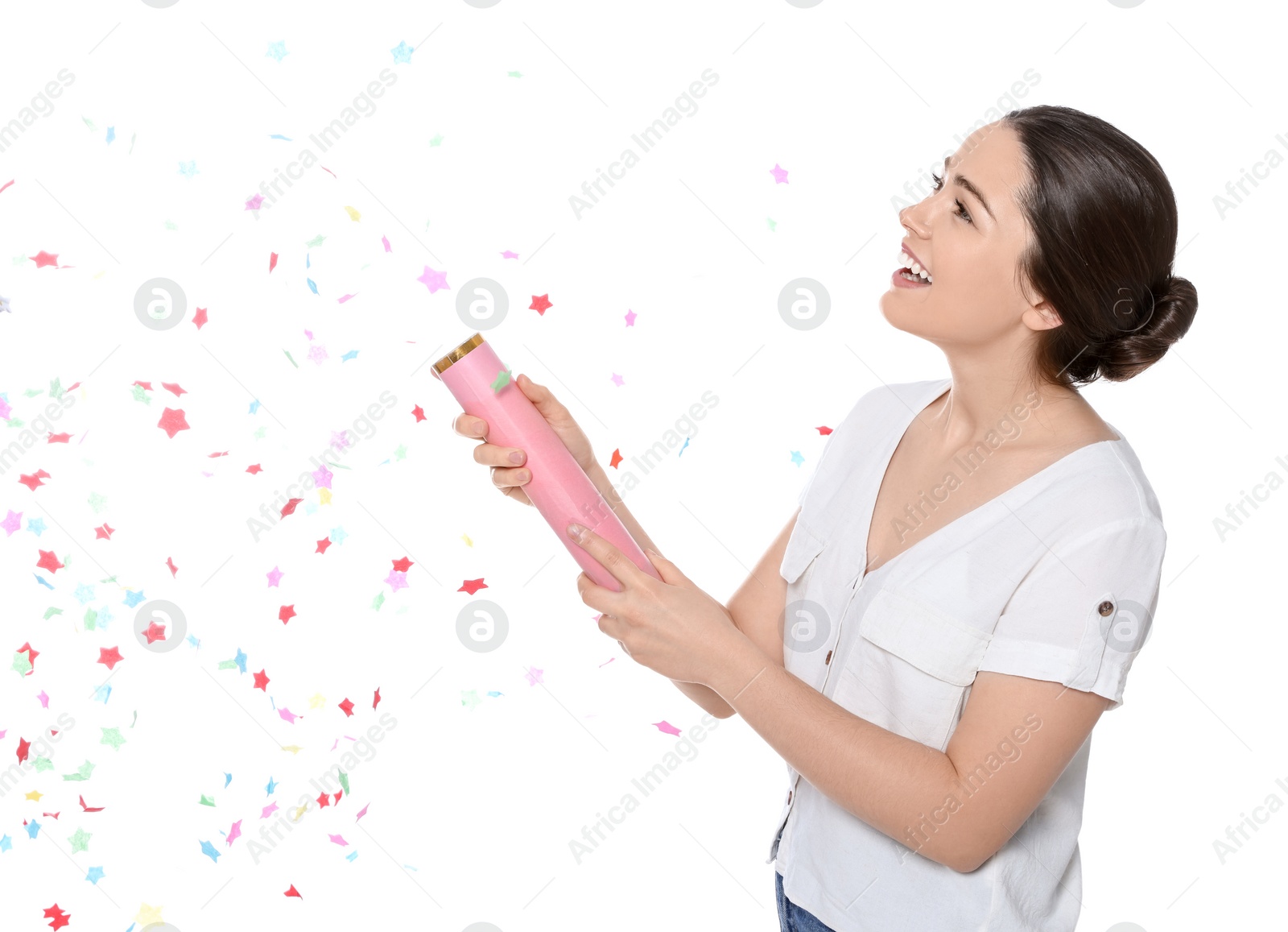 Photo of Young woman blowing up party popper isolated on white