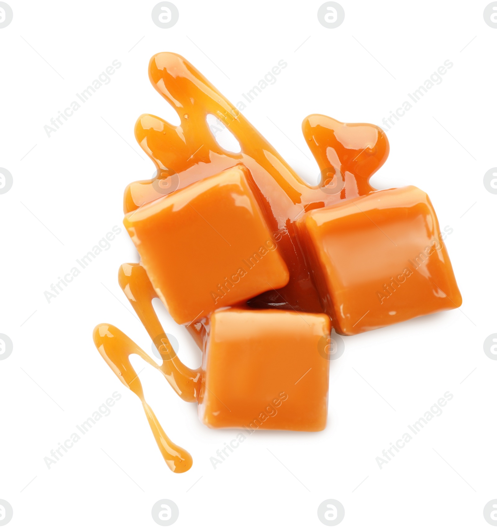 Photo of Sweet caramel candies with topping isolated on white, top view