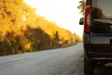 Photo of Car parked on country road. Space for text